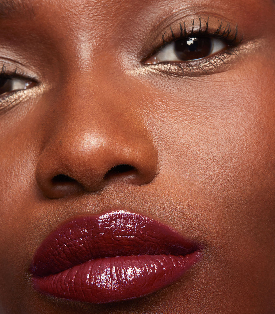 model wearing tinted lip balm in berry moon