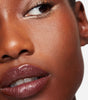 model wearing tinted lip balm in magnetic mauve 