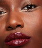 model wearing tinted lip balm in berry moon 
