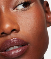 model wearing tinted lip balm in magnetic mauve | Essence wears Serum Balm Intense in Magnetic Mauve
